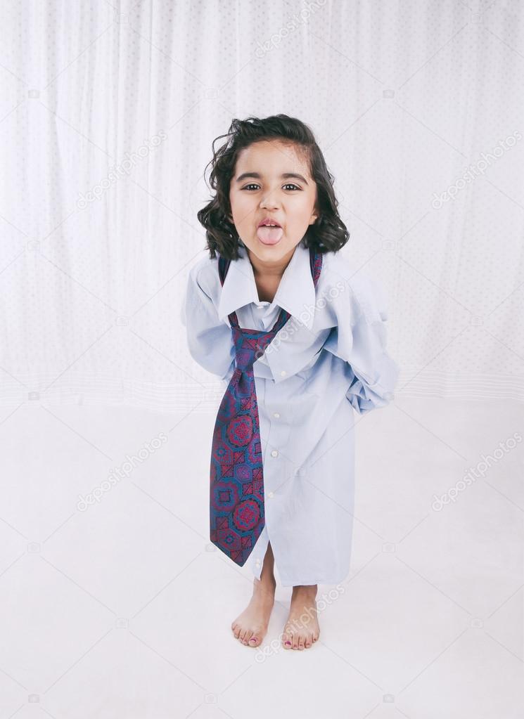 Portrait of a girl wearing oversize shirt with tie and sticking