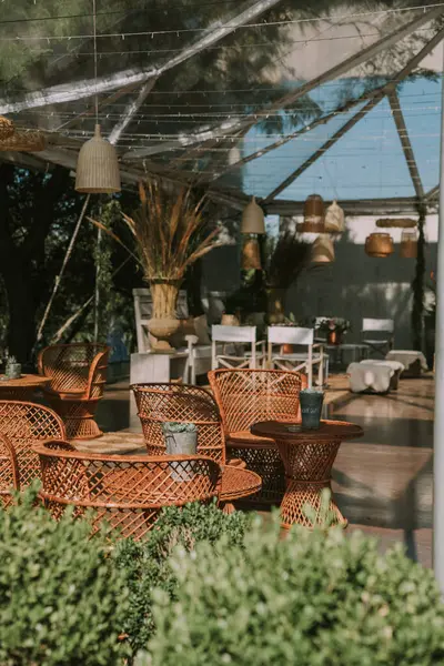 Koltuklar ve bahçe masası tencere, çiçek ve taklit deri kumaşlarla süslenmiş..