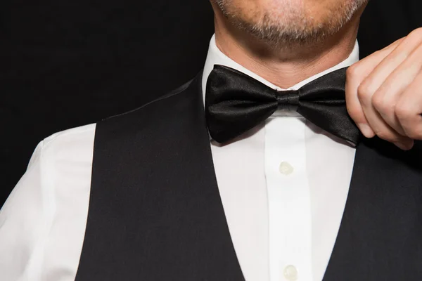 Gentleman in Waistcoat Straightens Bowtie. — Stock Photo, Image