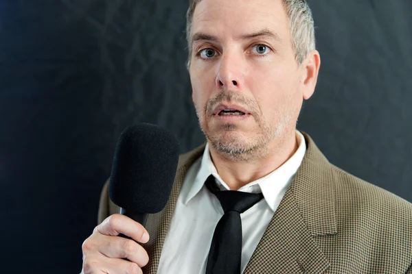 Depressed Man Speaks Into Microphone Stock Photo