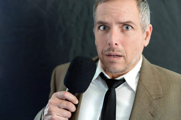 Anxious Man Speaks Into Microphone Royalty Free Stock Images