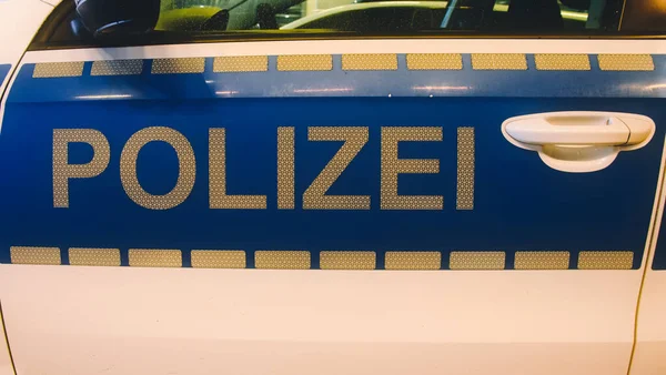 German police (german: Polizei) sign in white letters on a police car