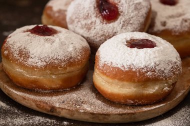 Ahşap arka planda reçelli lezzetli çörekler - Hanuka kutlaması konsepti