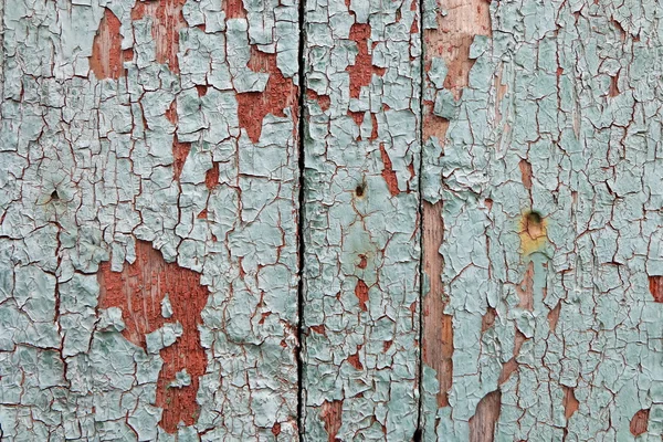 Descascamento de tinta em um fundo de madeira — Fotografia de Stock