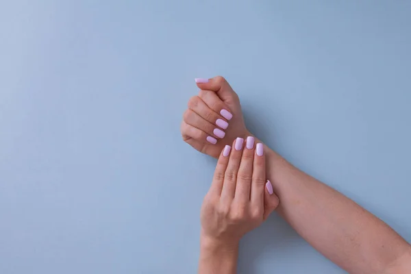 Primer plano de las manos de una joven con manicura rosa. — Foto de Stock