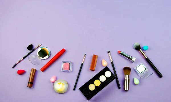 Lots of makeup on a purple background — Stock Photo, Image