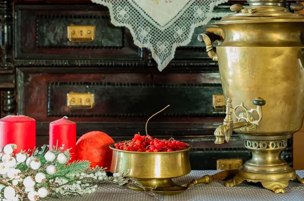 Retro tableware made of brass, candles, viburnum berry, christmas eve — Stock Photo, Image