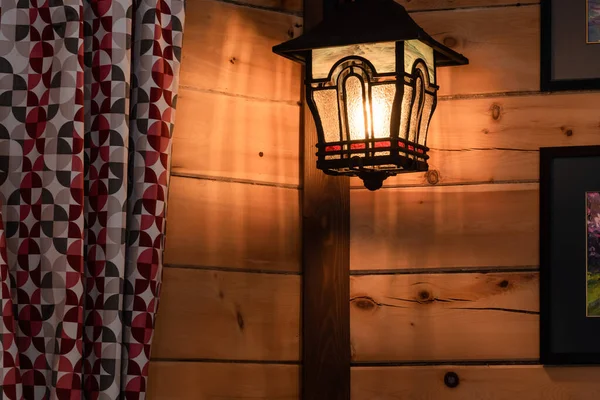 Interior of a room with a hanging lantern on a wooden wall — Stock Photo, Image