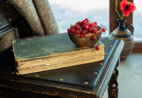 An old book lies on an old chair by the window — Stock Photo, Image