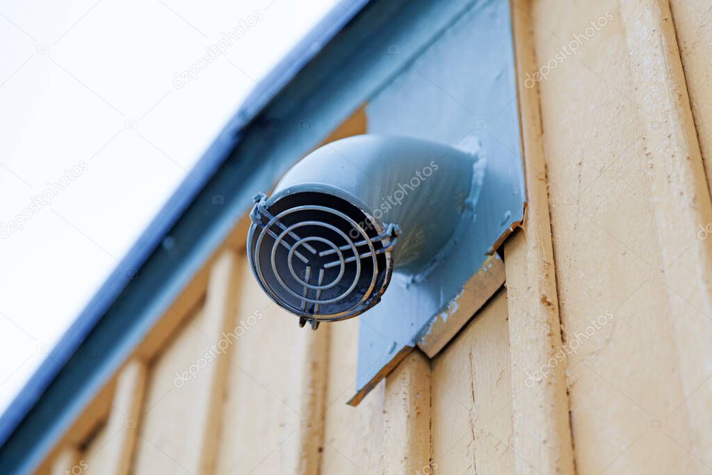 a small fan mounted on the house facade