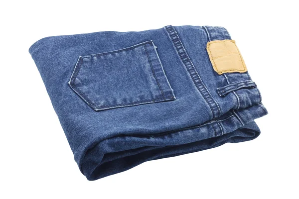 Katlanmış mavi kot pantolon deri etiket ile — Stok fotoğraf