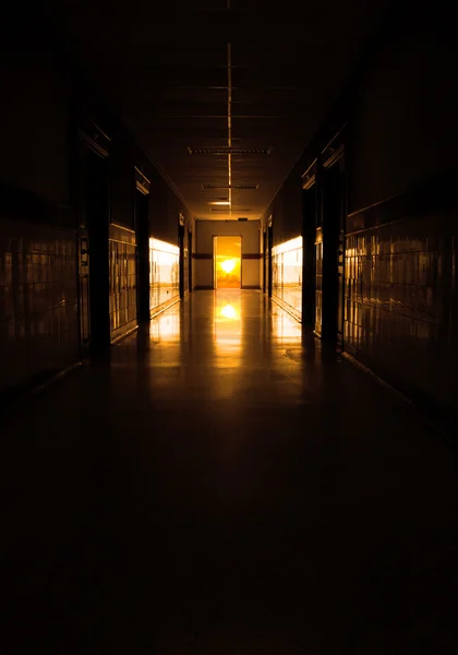 dark corridor to sun at the door 