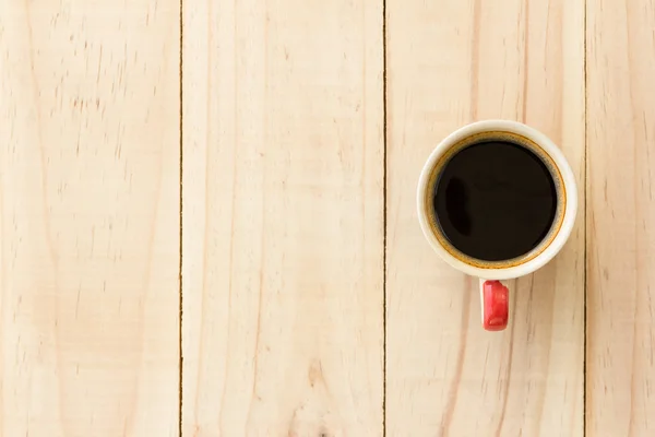 Cup of coffee on wooden table — Stock Photo, Image