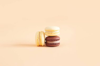 Sarı pastel arka planda lezzetli Fransız badem kurabiyeleri. Metin için yer.