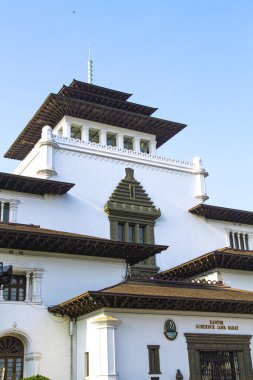 The view of Gedung Sate. Grand Dutch colonial administration building dating to the 1920s, now West Java's government house in Bandung City, Indonesia. clipart