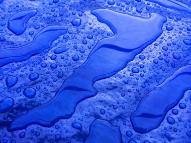 Droplets of rainwater on the blue tarp clipart