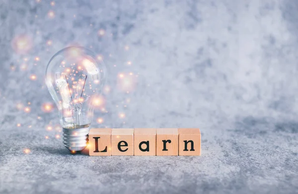 Cube letter word of Learn and light bulb with copy space. Self learning or education knowledge and business studying concept