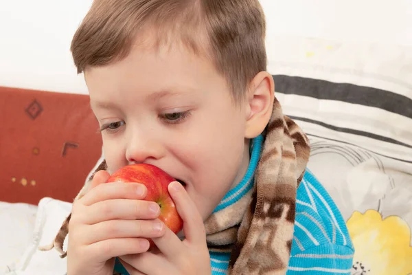 Sick Child Boy Blue Sweater Scarf Bed Eating Red Apple — Stock Photo, Image