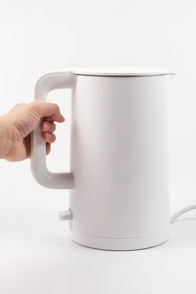 Female Hand Holds White Electric Kettle Handle White Wooden Table — Stock Photo, Image