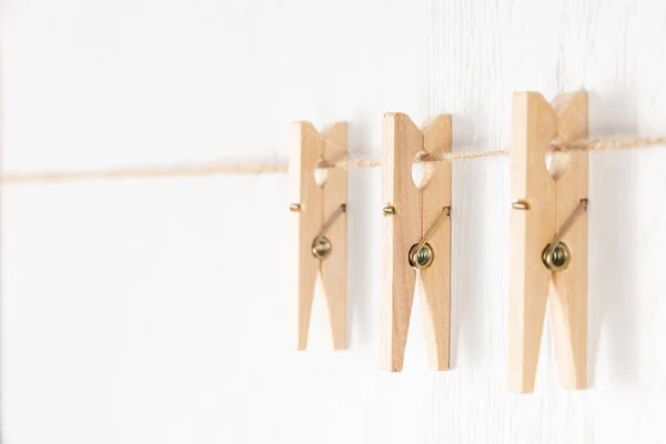 Three Wooden Clothespins Metal Spring Hang Rope White Background Selective — Stock Photo, Image