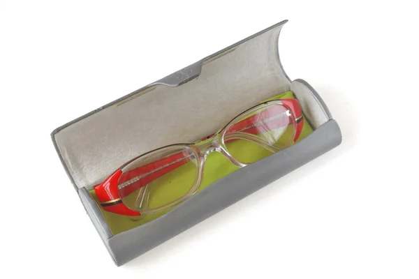 Red-rimmed glasses lie in a case for glasses — Stock Photo, Image