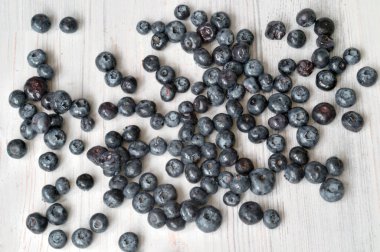 blueberry berry scattered on a light table
