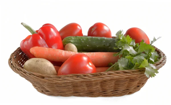 Fresh vegetables are in a wicker basket isolated on white backgr — Stock Photo, Image