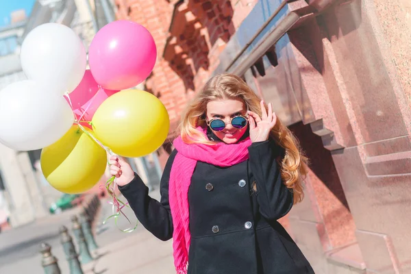 Beautiful woman with colorful balloons — Stock Photo, Image