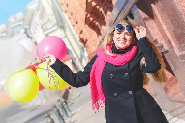 Beautiful woman with colorful balloons — Stock Photo, Image