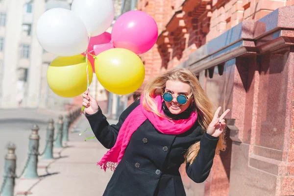 Beautiful woman with colorful balloons — Stock Photo, Image