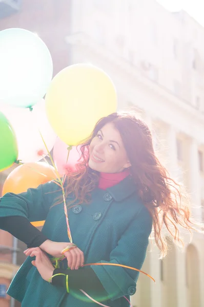 Beautiful woman with colorful balloons — Stock Photo, Image