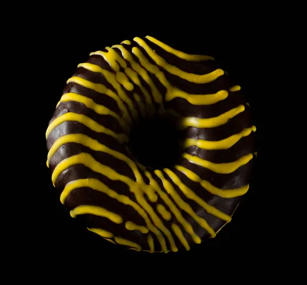 American donut covered with chocolate on black background — Stock Photo, Image