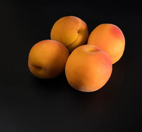 Four Ripe Fruits Apricot Black Background Isolated — Photo
