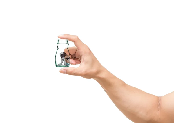 Man hand catching the Sad woman sitting alone in a jar on white background — Stock Photo, Image