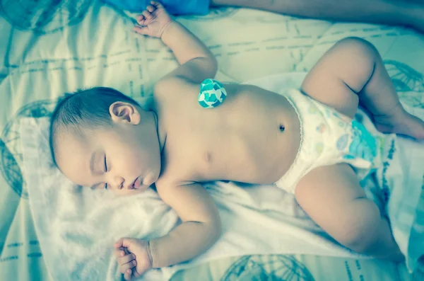 Asian baby sleeping with blue heart — Stock Photo, Image