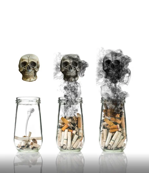 Cigarette butt in bottle with smoke Burning the life to be skull, world no tobacco day — Stock Photo, Image