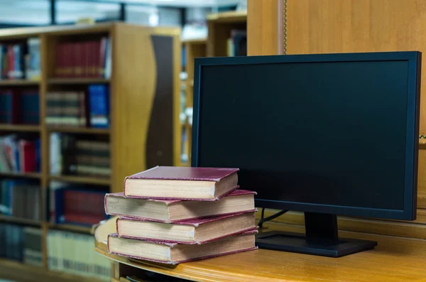 Old books with computer monitor — Stock Photo, Image