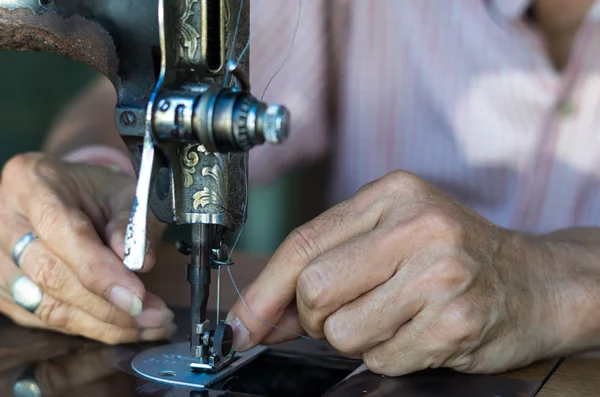 Vintage sewing machine and male hands