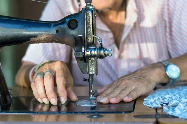 Male Dressmaker Using Sewing Machine by Stocksy Contributor