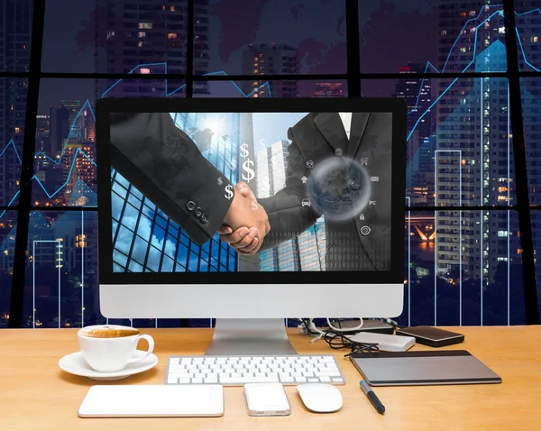 Workspace with computer desktop with Hand shake — Zdjęcie stockowe