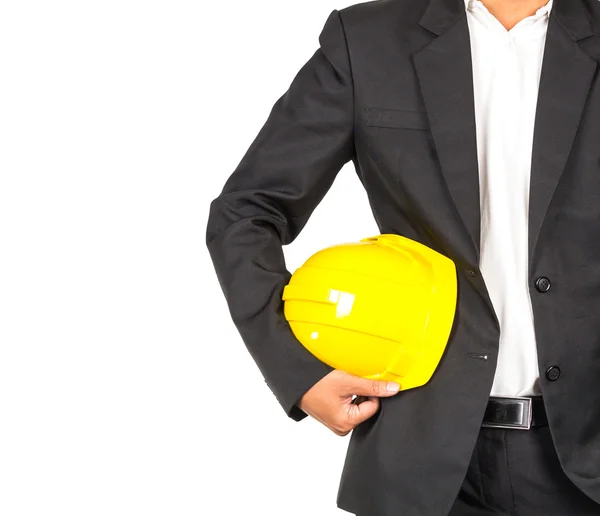 Μηχανικός στο κοστούμι κρατώντας κίτρινο κράνος — Φωτογραφία Αρχείου