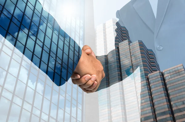 Double exposure handshake between businessmen — Stock Photo, Image