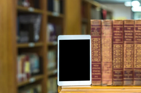 Tablet computer with old books — Stock Photo, Image