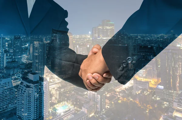 Double exposure handshake between businessmen — Stock Photo, Image