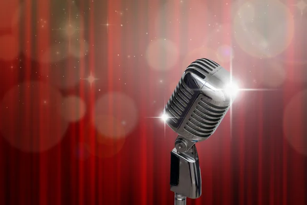 Retro microphone over red curtain — Stock Photo, Image