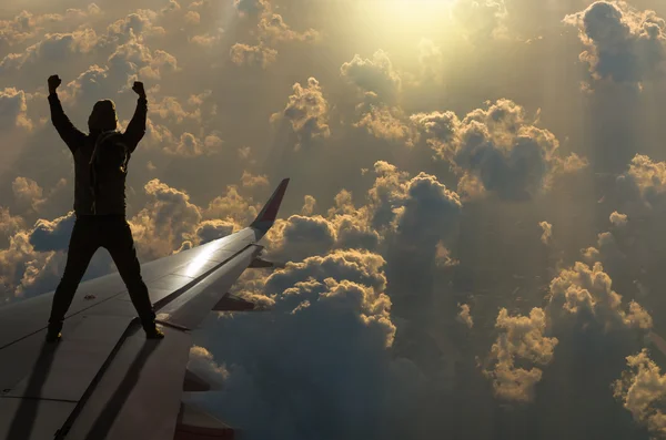 Silhouette of man on airplane wing — Stock Photo, Image