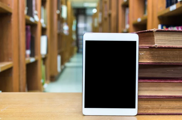 Tablet computer with old books — Stock Photo, Image