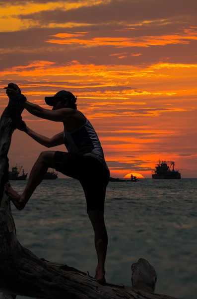 Silhouette of strong man climbing — Stock Photo, Image