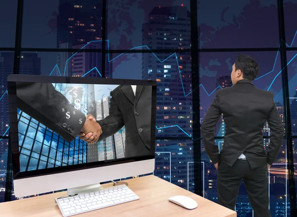 Computer with handshake between businessmen — Stock Photo, Image