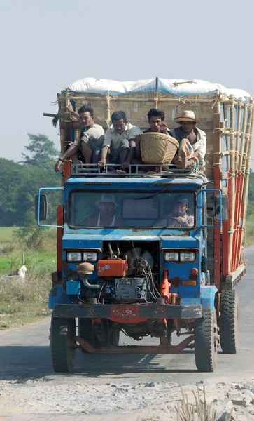 YANGON-MYANMAR NOV.23:Trucks are used to transport people to the village in countryside on Nov.23, 2012 Myanmar.They are used as a taxi because people can't effort there own transportation — Stock Photo, Image